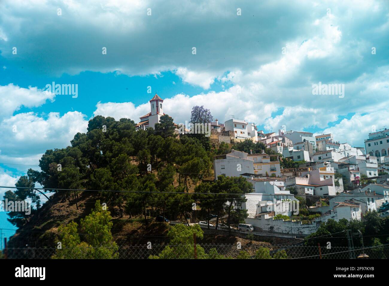 Spectacular View of the white town with the church at the top of the hill, Alozaina, Malaga Province, Andalusia, Spain, Western Europe. Stock Photo