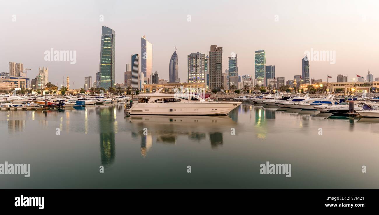 Panorama of Souq Sharq Marina in Salmiya, Kuwait, Arabian peninsula, Western Asia. Yachts in Water and Kuwait cityscape in the Background. Stock Photo