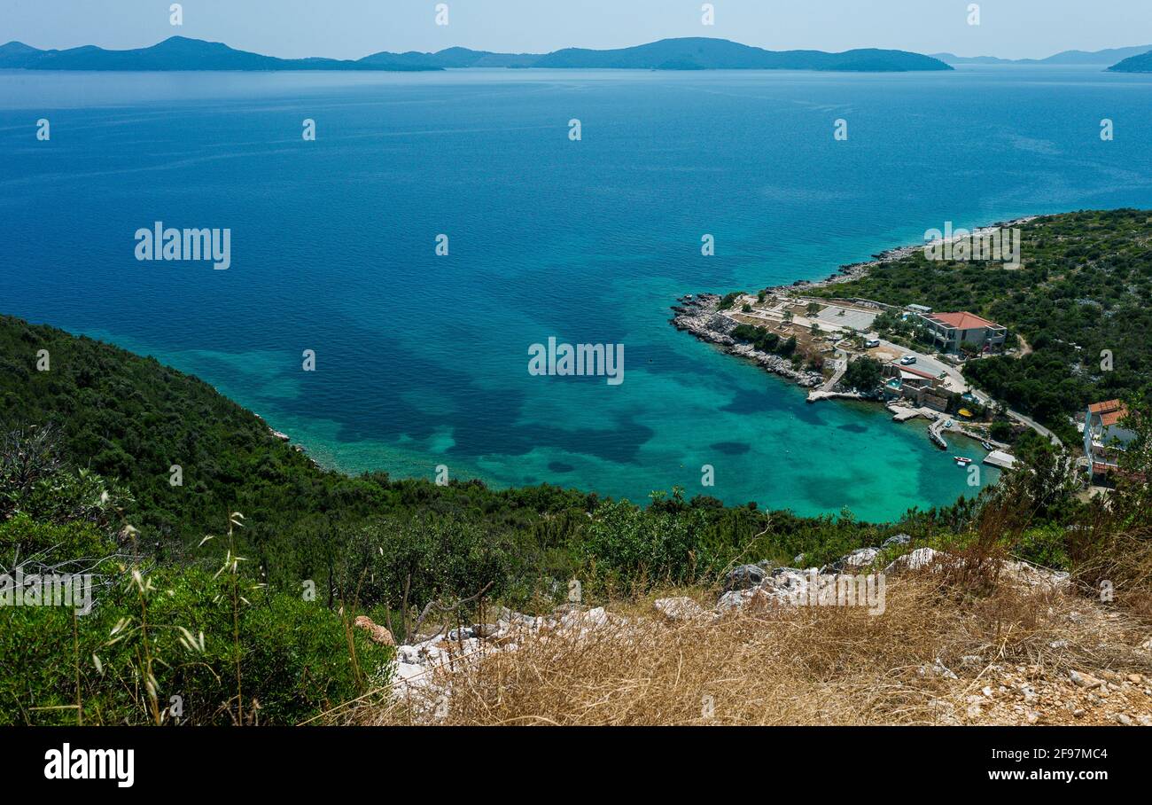 Aerial panorama view of the beautiful adriatic coast in croatia (near Dubrovnik). The water in the azure turquise lagoon is crystal clear and the sky with a range of islands is blue. Shot with Leica M9 Stock Photo