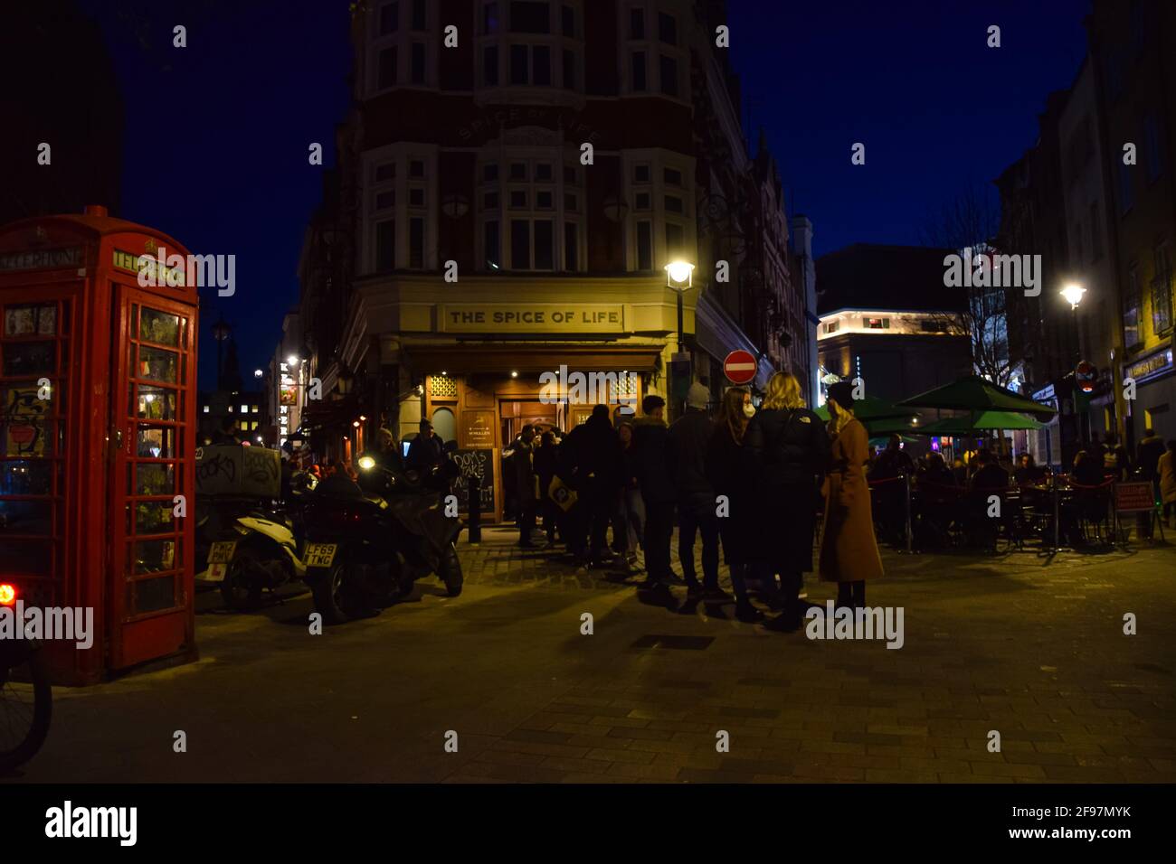 London, United Kingdom. 16th April 2021. A queue outside The Spice Of Life pub in Soho. Crowds of people packed the bars and restaurants in Soho, Central London, on the first Friday since lockdown rules were relaxed. Stock Photo