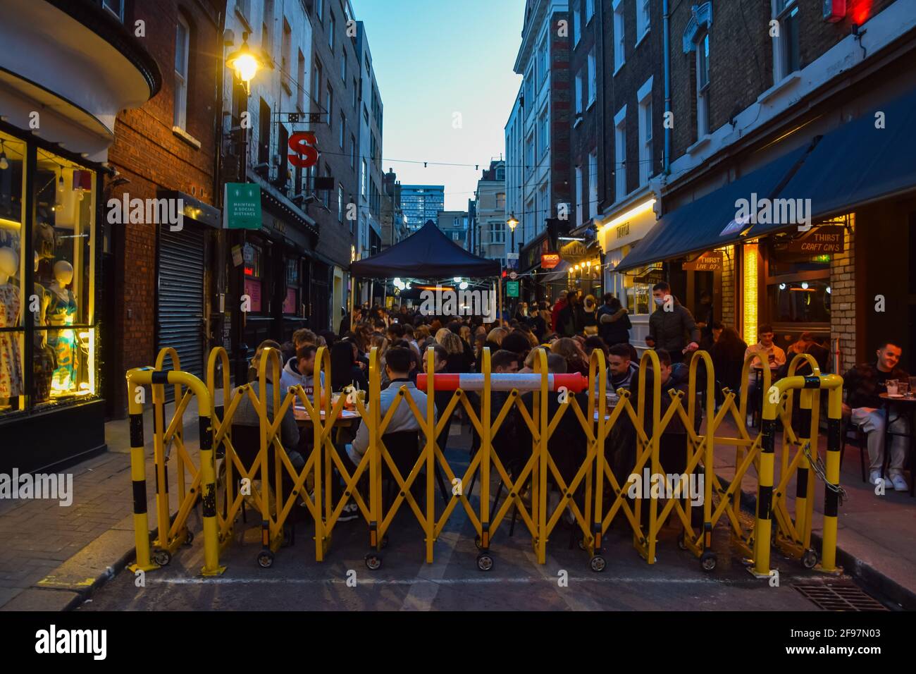 London, United Kingdom. 16th April 2021. A busy bar in Soho. Crowds of people packed the bars and restaurants in Central London on the first Friday since lockdown rules were relaxed. Stock Photo