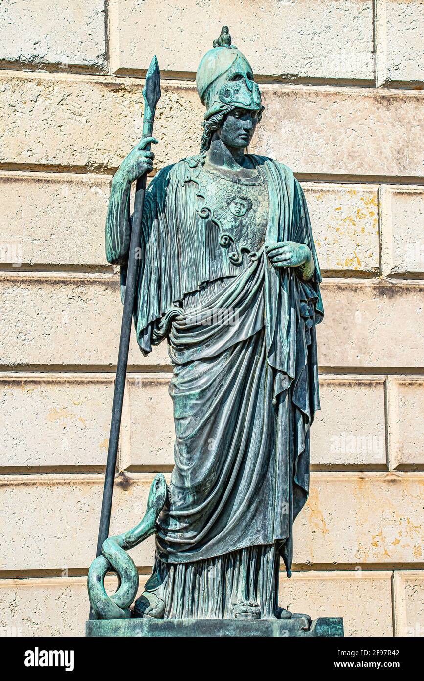 Old statue of a Roman armed soldier with spear and helmet, and a snake