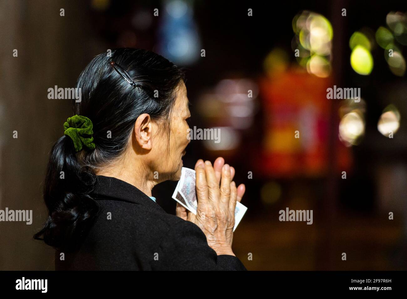 Vietnam, Tay, Tay Phuong Pagoda, elderly woman, prayer, sideways Stock Photo