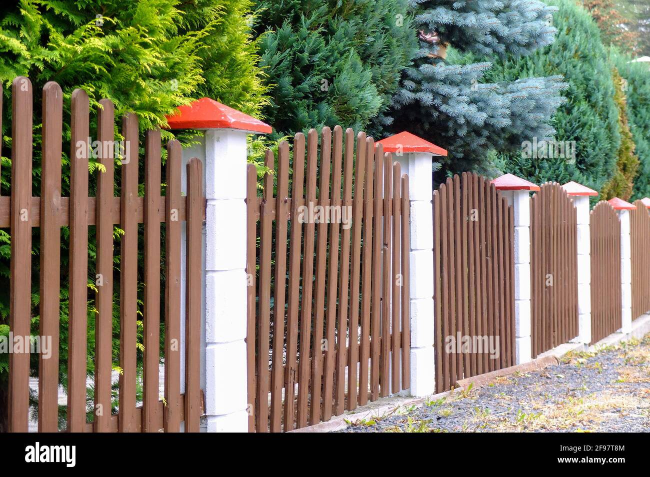 Wooden fence in toadstool look Stock Photo