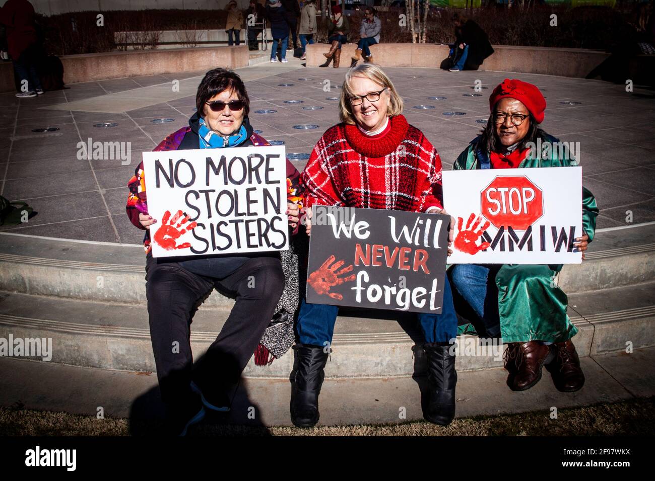 2020 01 18R Tulsa USA Three women sit at protest march in Tulsa with signs - No more stolen sisters We will never forget and Stop MMIW Stock Photo