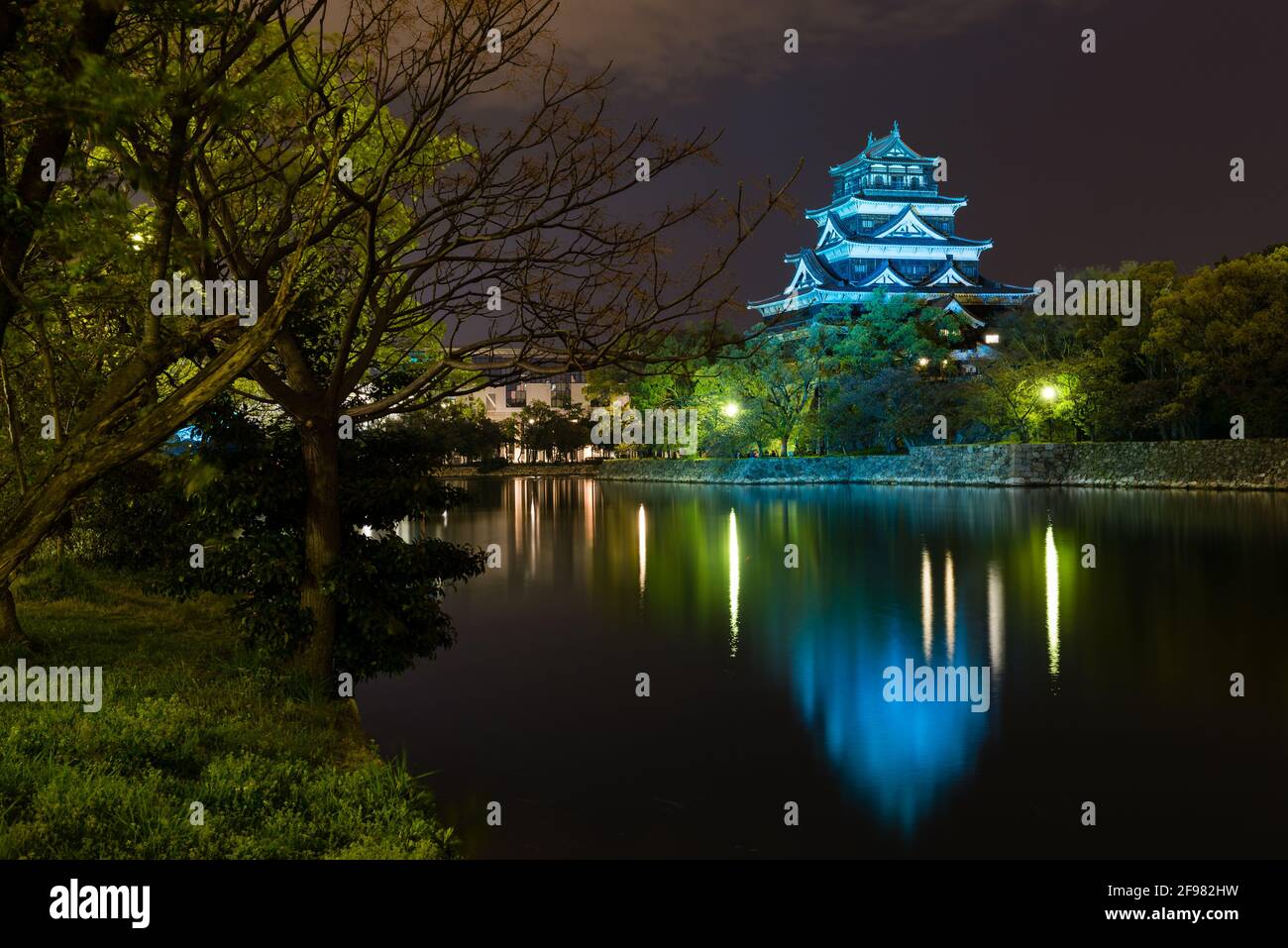 Hiroshima castle fully lit on a cloudy night at Hiroshima, Japan Stock Photo