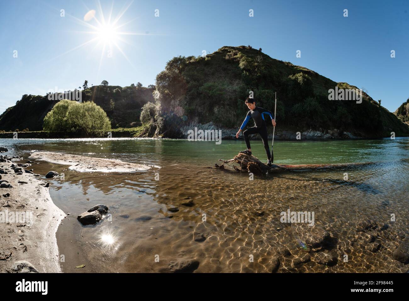 Tween boy exploring river in Hawke's Bay New Zealand Stock Photo