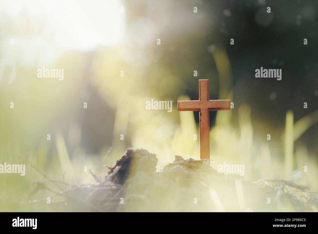 Cross on blurry sunset background Stock Photo - Alamy