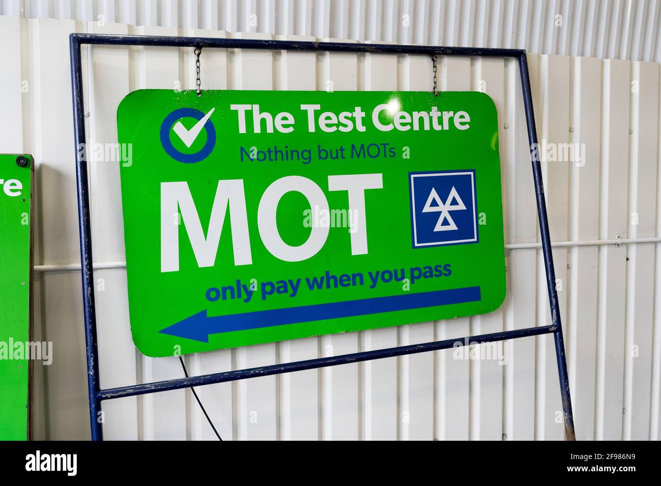 MOT test centre with logo of MOT, three triangles in white on green background Stock Photo