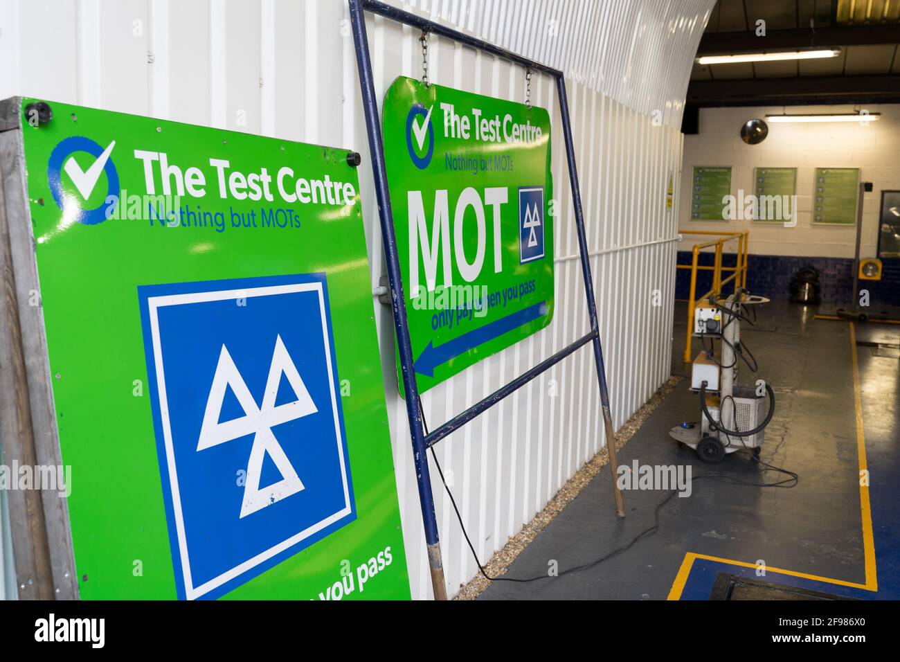 MOT test centre with logo of MOT, three triangles in white on green background Stock Photo