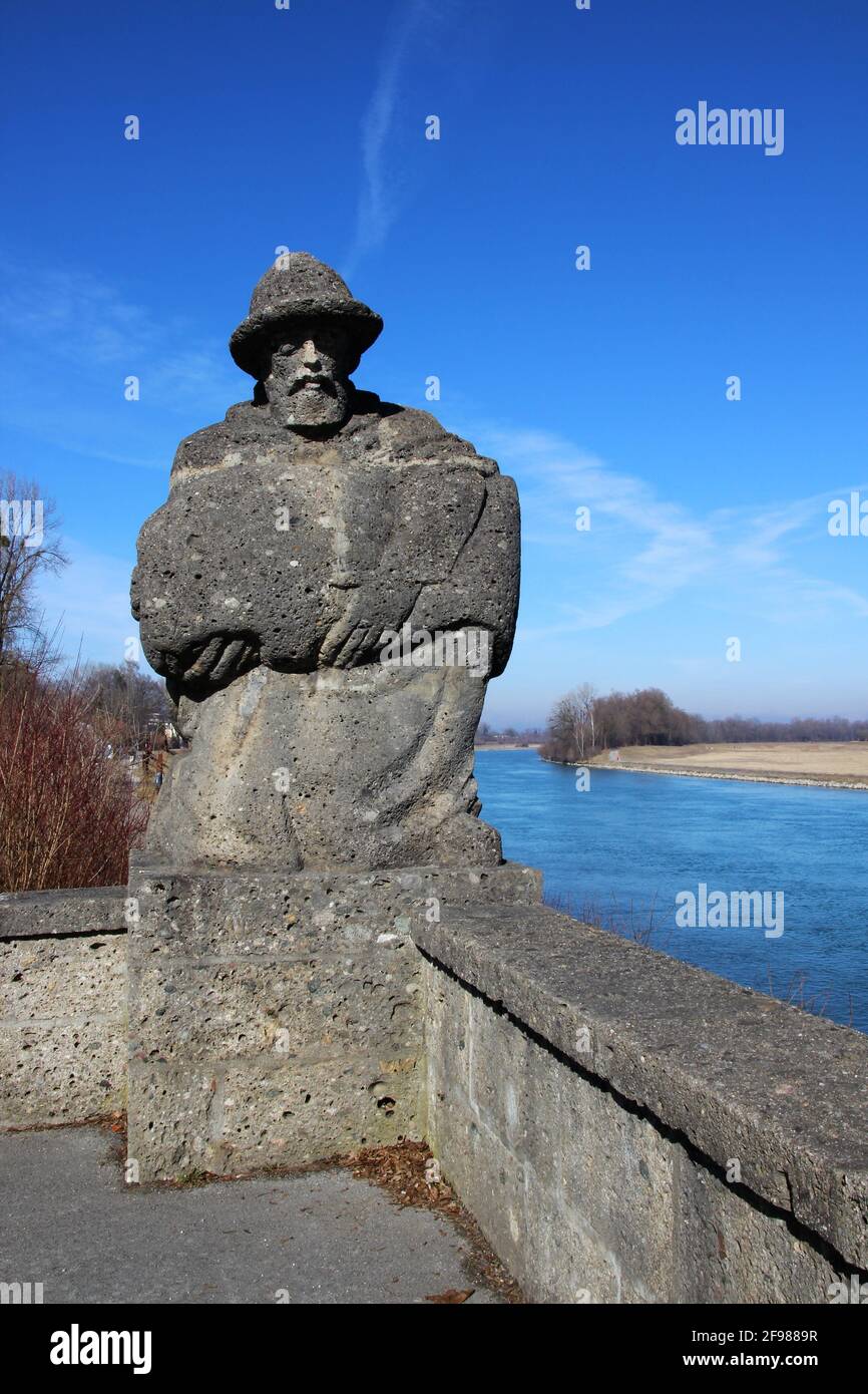 Statue of the Salzmann or Salzsackträger, from Nagelfluh, 1963, on the left at the Inn Bridge in the city of Rosenheim, executed by the sculptor Konstantin Frick / Toni Fiedler. The locals affectionately call the figure the root sep Stock Photo