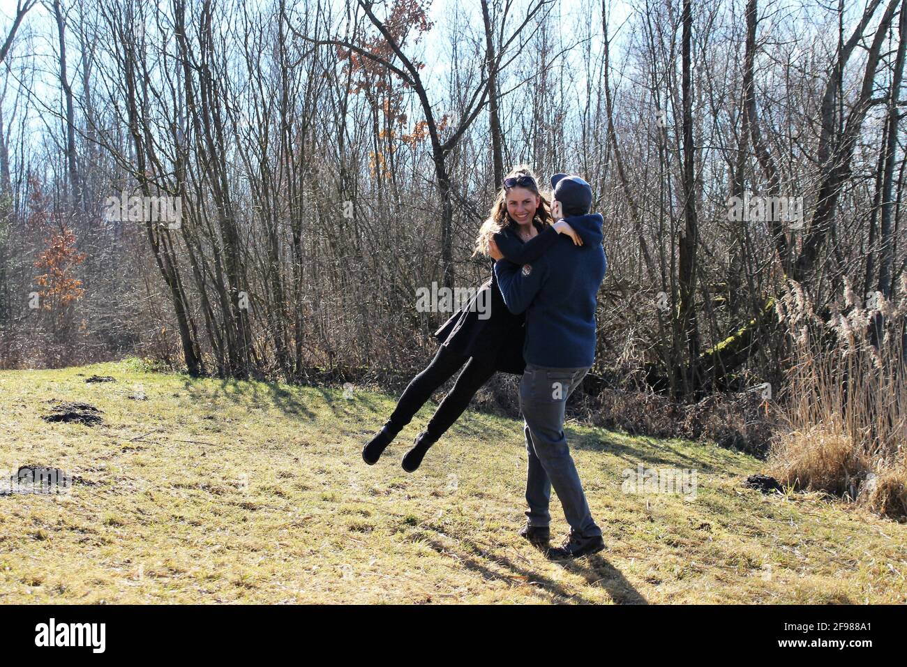 Winter trip to Rosenheim, couple hugging in a meadow Stock Photo