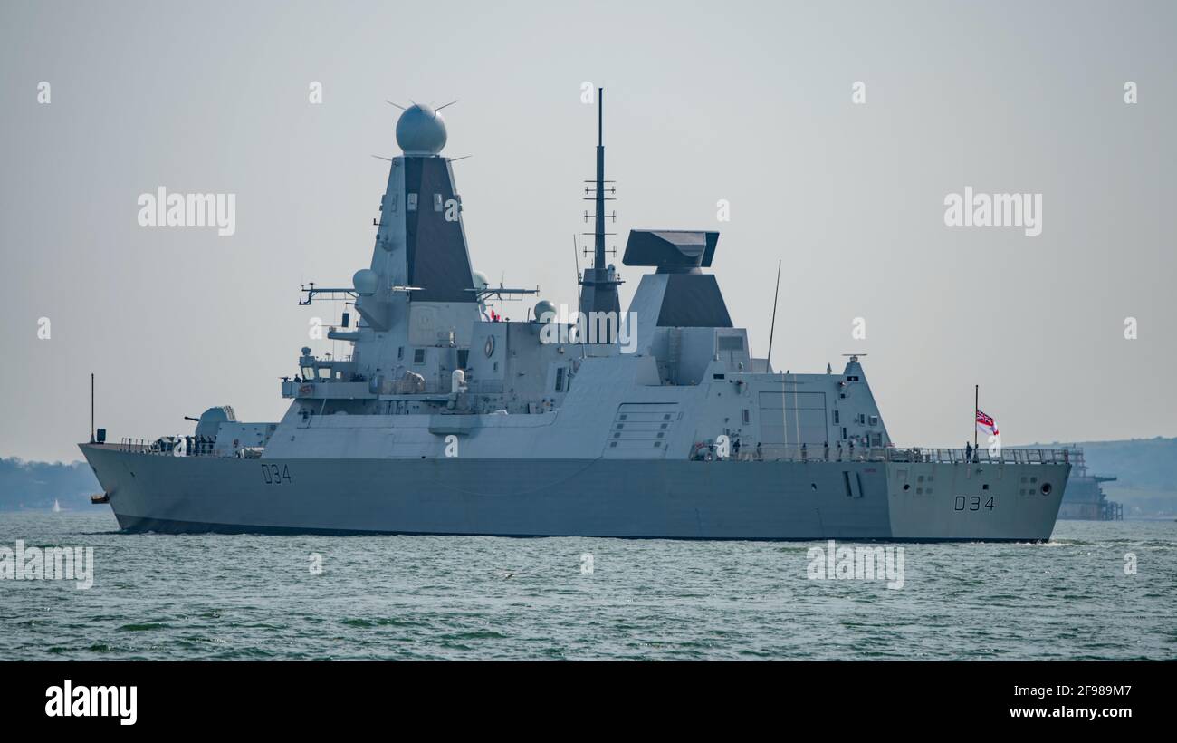 HMS Diamond proceeding to sea from Portsmouth, UK on 16/4/21.The ship's White Ensign is worn at half mast for HRH Prince Philip The Duke of Edinburgh. Stock Photo
