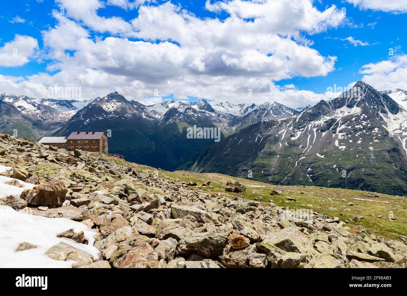 Alpine mountain landscape with snow-capped peaks and mountain hut on a sunny early summer day. Ötztal Alps, Tyrol, Austria Stock Photo