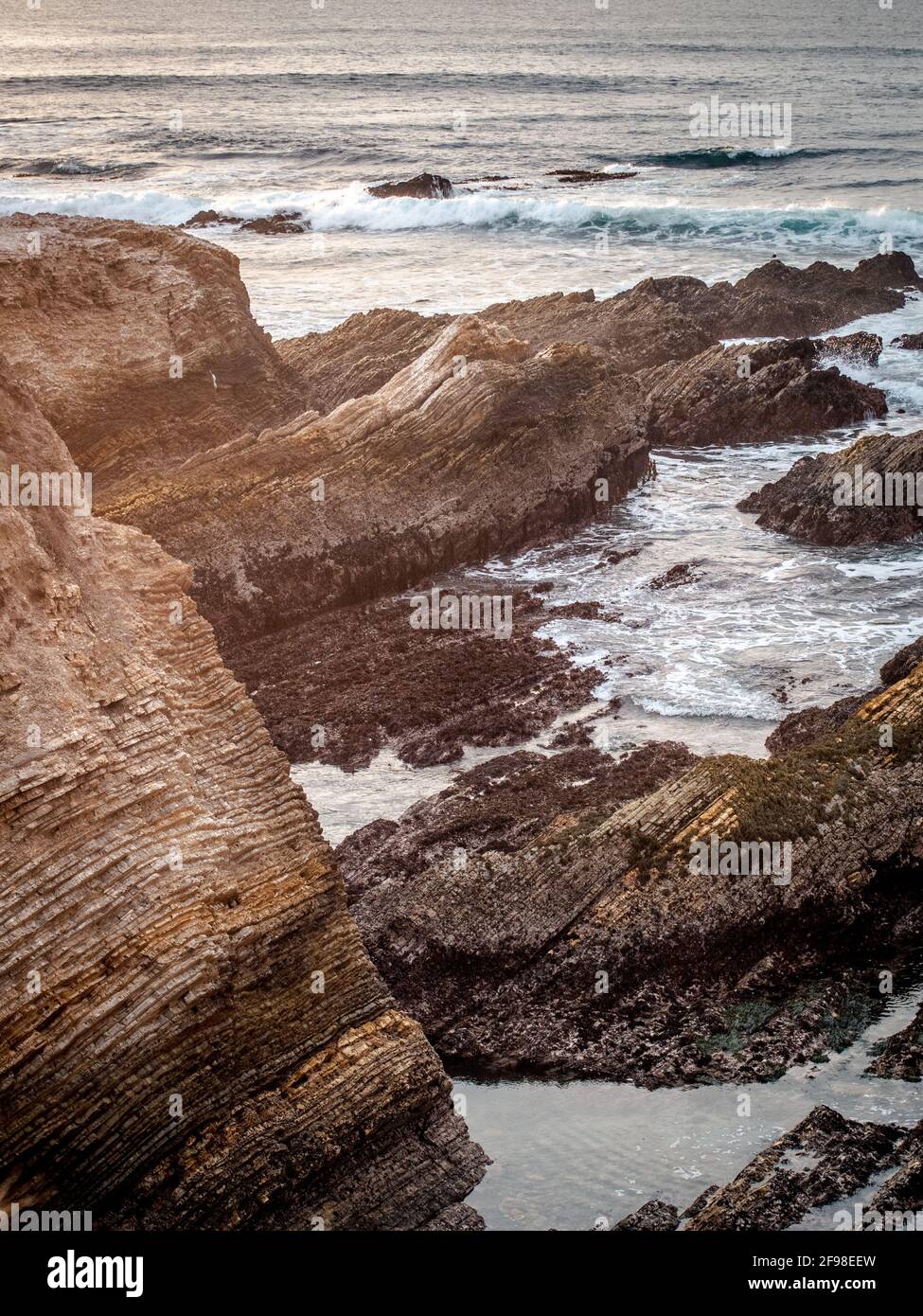 Vertical shot of a rocky shore under sunlight Stock Photo - Alamy