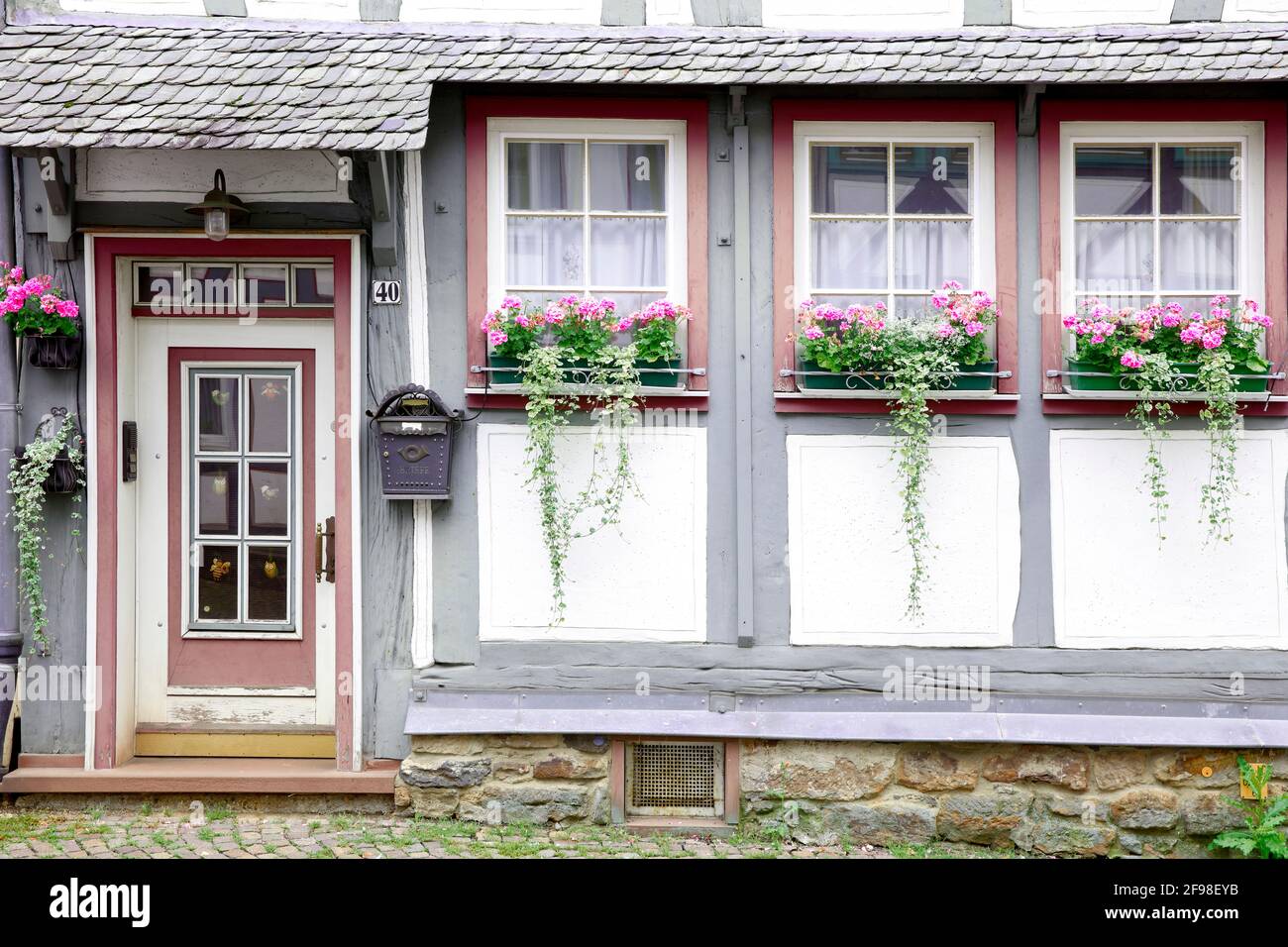 House facade, front door, window, floral decoration, summer, Alsfeld, Vogelsbergkreis, Hesse, Germany, Europe Stock Photo