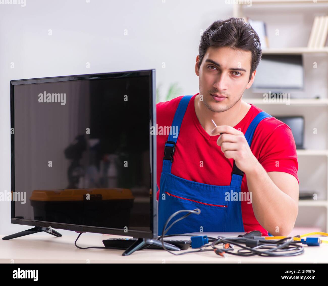 Tv Engineering Making The professional repair engineer repairing broken tv Stock Photo - Alamy