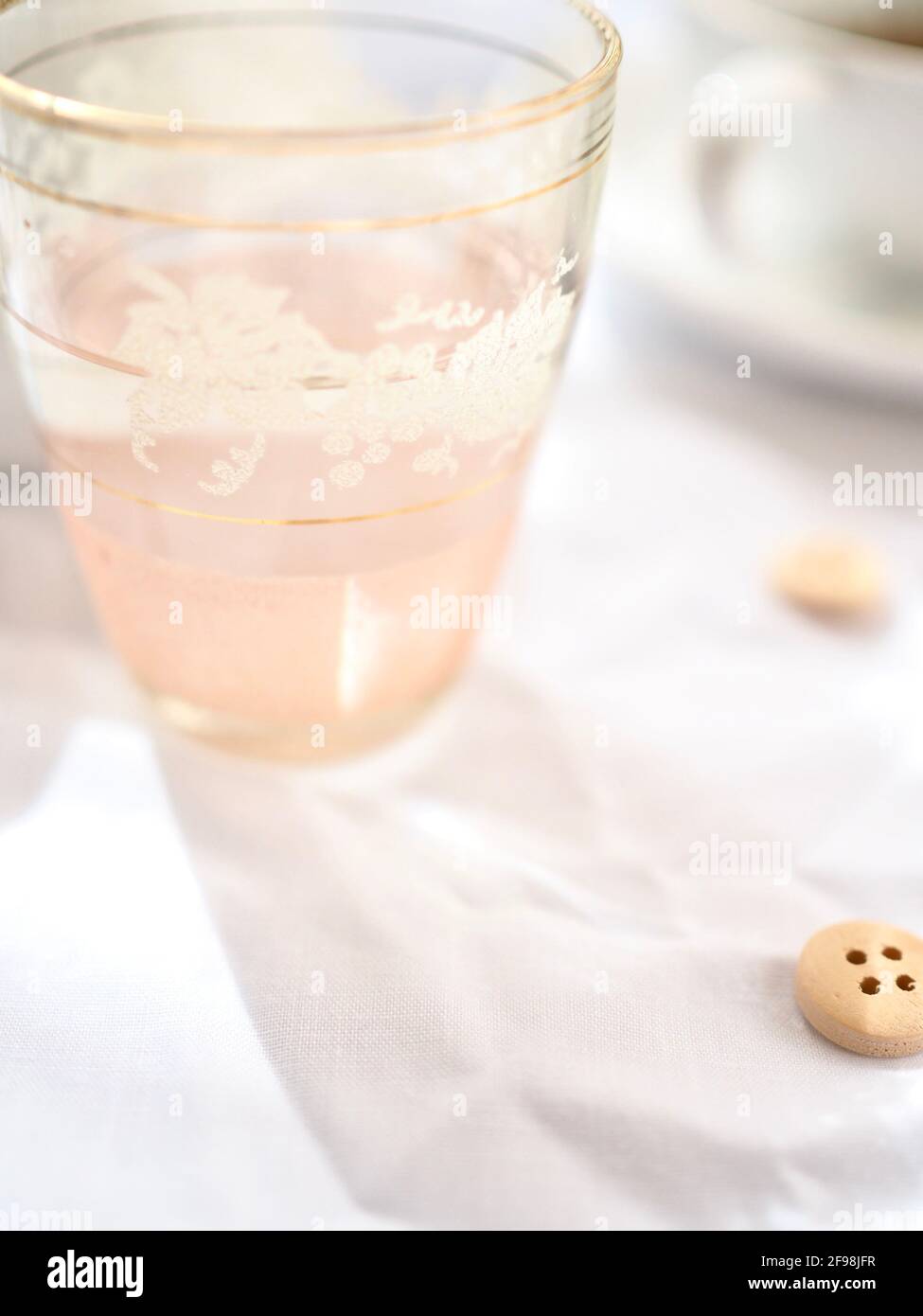 Pretty pink glass in the light with a bright white background Stock Photo