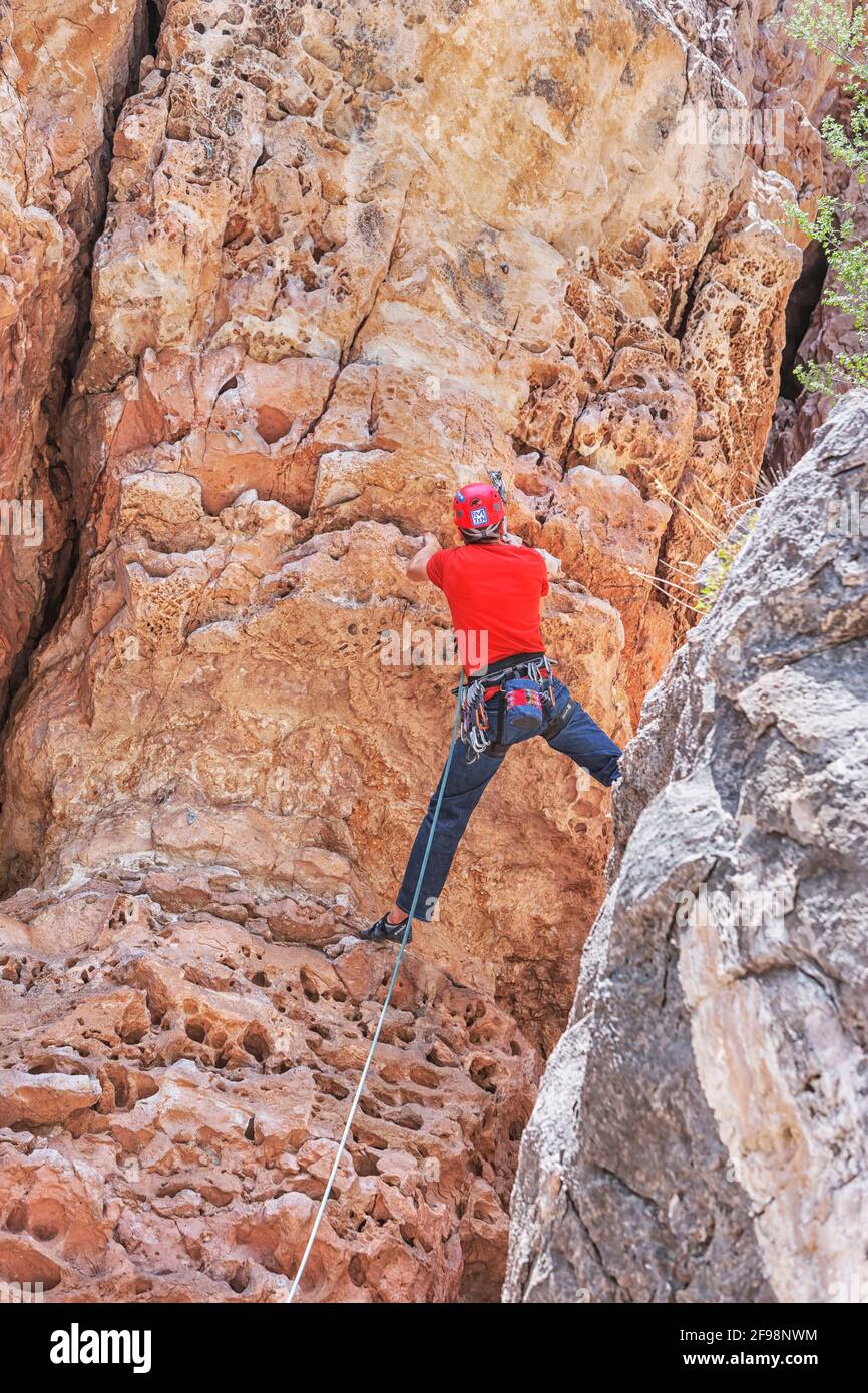 Man rock climbing at 'The Pit' in Sandy's Canyon, Flagstaff, Arizona