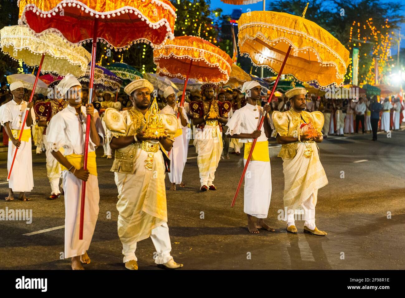 Sri Lanka, Colombo, Gangaramaya temple, the Nawam Maha Perahera festival, men, umbrellas, procession, Stock Photo