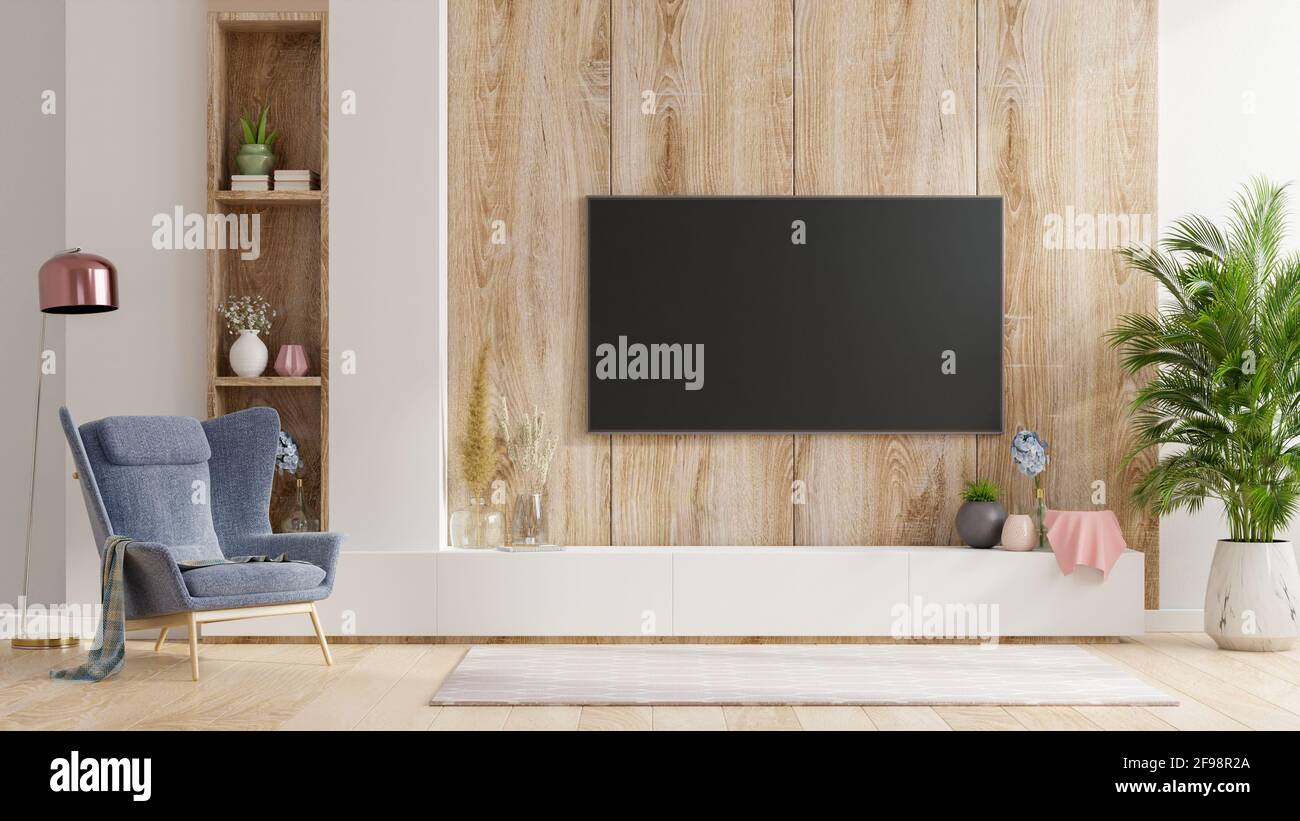 Smart TV on the wooden wall in living room with armchair,minimal design,3d  rendering Stock Photo - Alamy