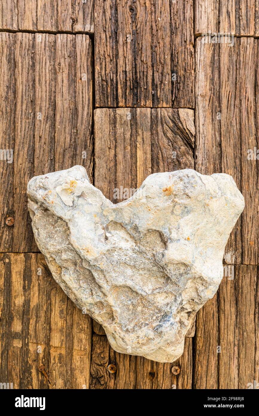 Heart made of stone, heart-shaped stone on a wooden surface, still life  Stock Photo - Alamy