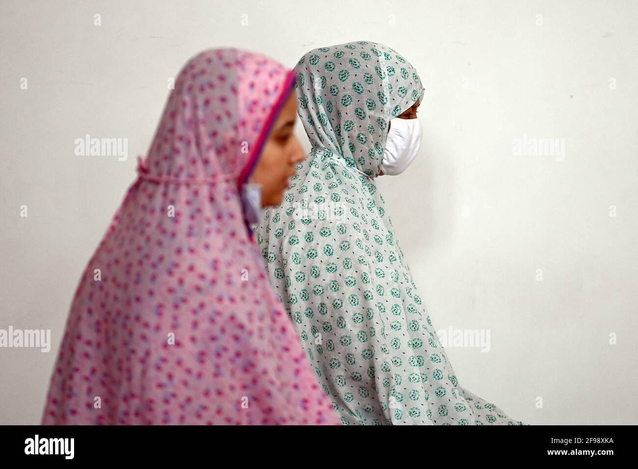 New York, USA. 16th Apr, 2021. Two woman of muslim faith pray on the second floor (above and behind the men) of the Bosniak Islamic Cultural Center Mosque during Ramadan, in the Queens borough of New York City, NY, April 16, 2021. Ramadan is observed worldwide by Muslims as a time of prayer and reflection, and is marked by fasting from sunrise to sundown, lasting 30 days, and is considered on of the five pillars of Islam. (Photo by Anthony Behar/Sipa USA) Credit: Sipa USA/Alamy Live News Stock Photo