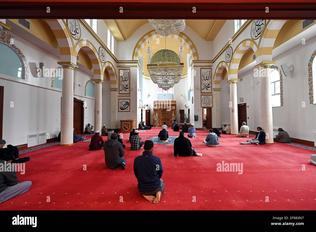 New York, USA. 16th Apr, 2021. A group of Muslim men gather for early afternoon prayers on the ground floor of the Bosniak Islamic Cultural Center Mosque during Ramadan, in the Queens borough of New York City, NY, April 16, 2021. Ramadan is observed worldwide by A group of Muslims as a time of prayer and reflection, and is marked by fasting from sunrise to sundown, lasting 30 days, and is considered on of the five pillars of Islam. (Photo by Anthony Behar/Sipa USA) Credit: Sipa USA/Alamy Live News Stock Photo
