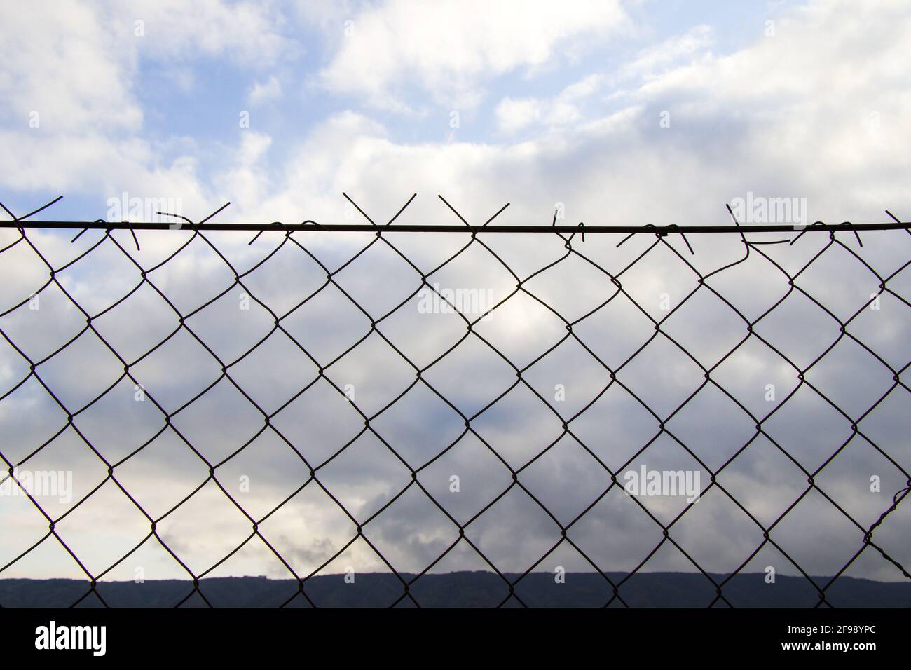 Closeup shot of a grid fence with a cloudy sky background Stock Photo ...