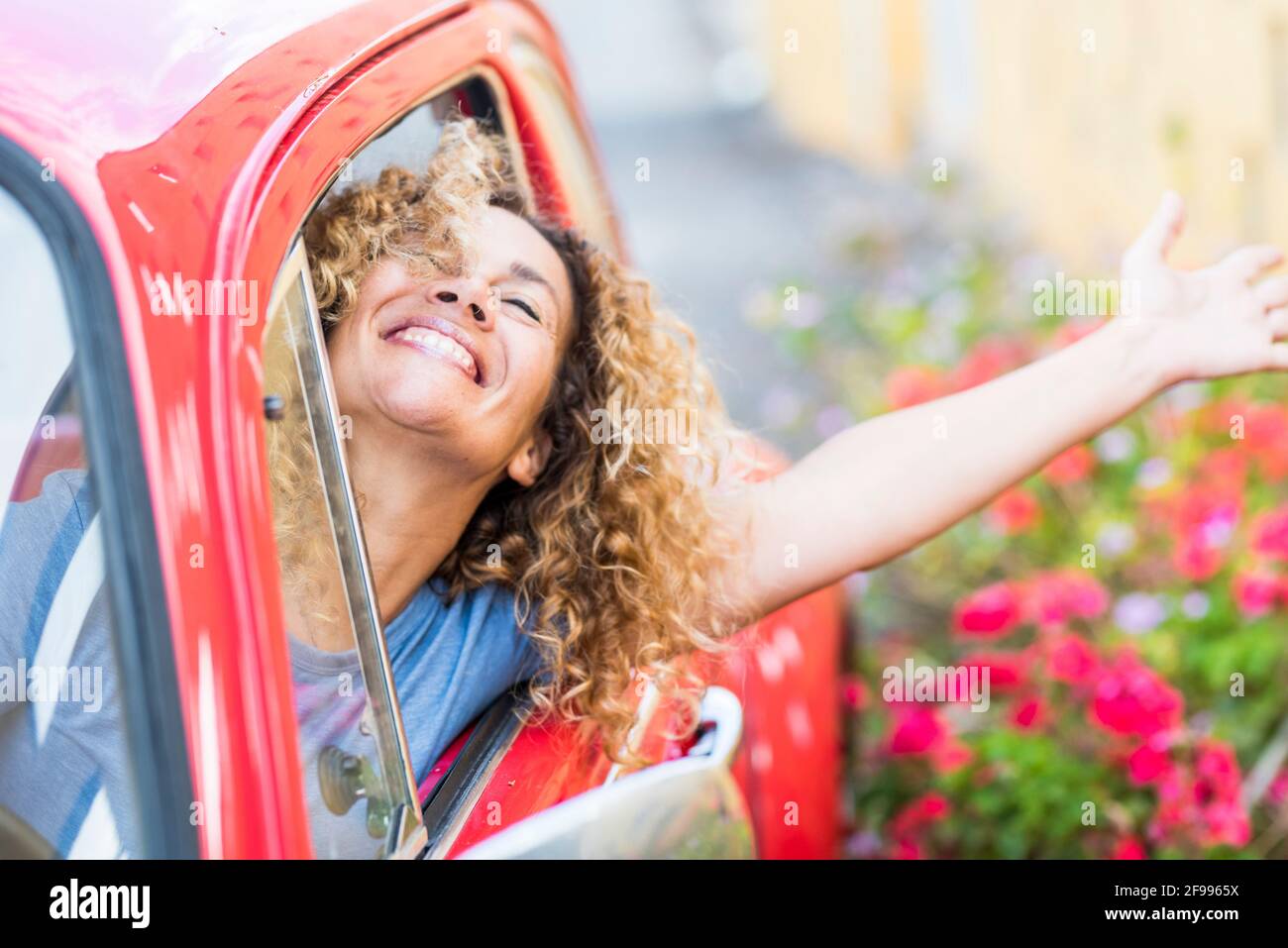 Young woman enjoy drive the car and travel - happy people female dricing vehicle and having fun - concept of female and automobile - free person traveling and laughing Stock Photo