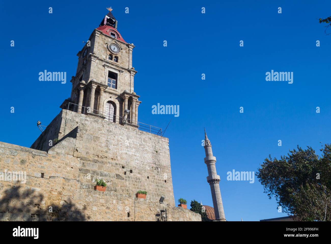 Low angle of the historical Medieval Clock Tower Roloi under the blue sky in Rhodes, Greece Stock Photo