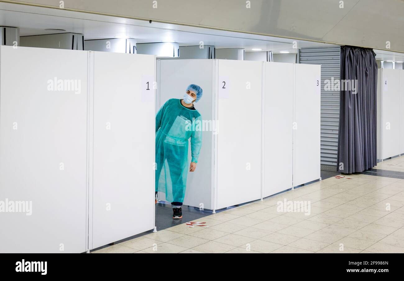 Essen, North Rhine-Westphalia, Germany - Corona test center Grugahalle open for free citizen test, Covid quick test, a pharmacist who carries out the quick test waits in front of his cabin for the next test person, from March 8th, German citizens can test Corona once a week for free Have the rapid test center tested. Stock Photo