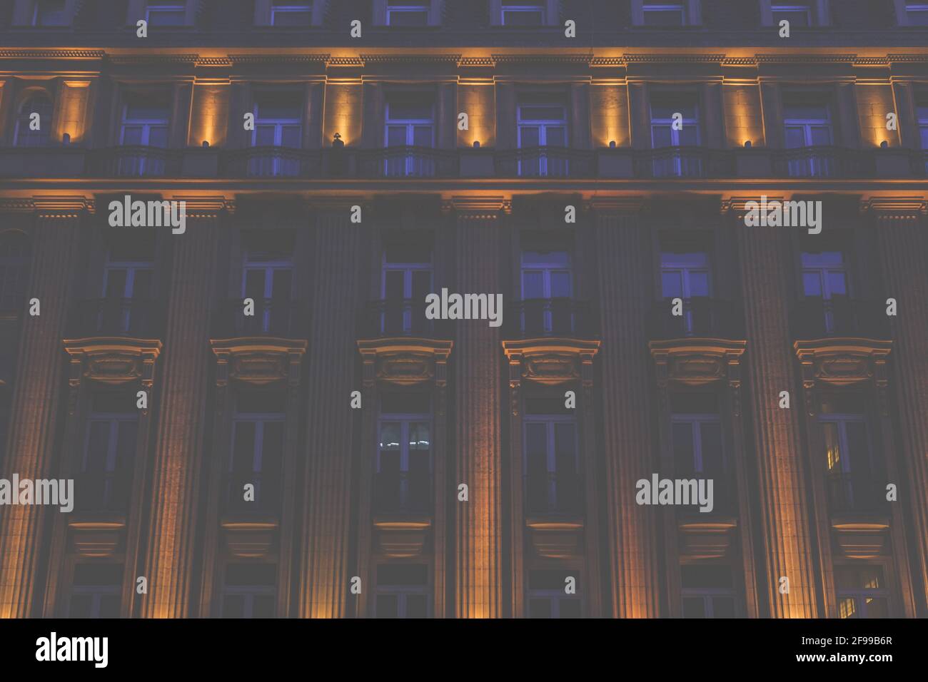 Illuminated exterior facade of a house in the classical style at night, Cologne, Germany, Europe Stock Photo