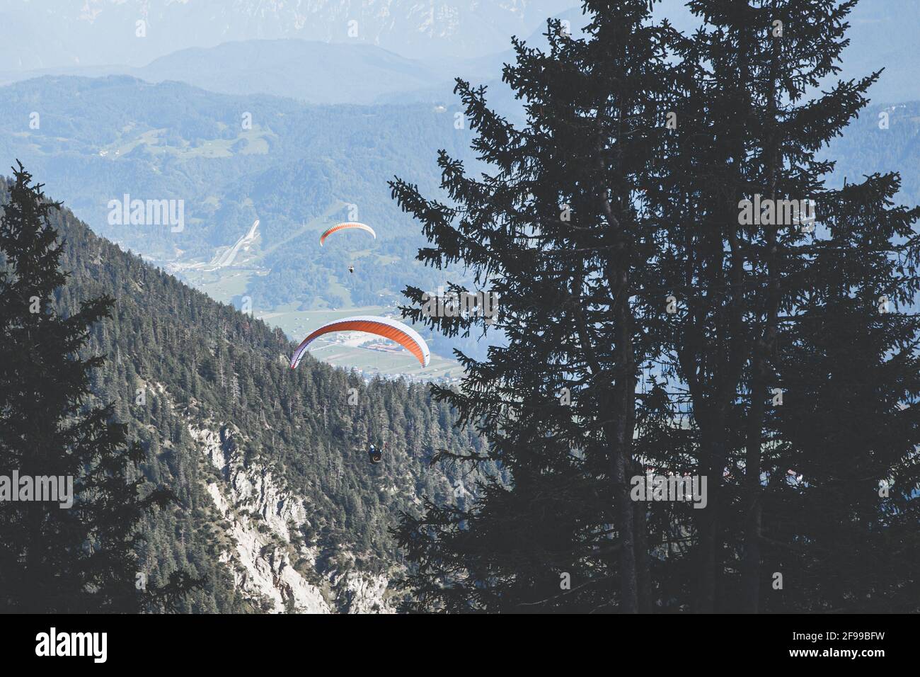 Two paragliders over Garmisch-Partenkirchen, the ski jump in the background Stock Photo