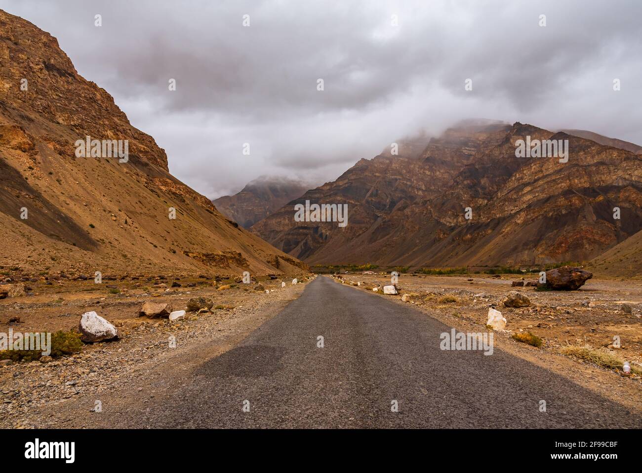 Road travels through high plateau of Spiti. It is cold desert composed of austere barren mountains & deep gorges of fierce Spiti River which is advent Stock Photo