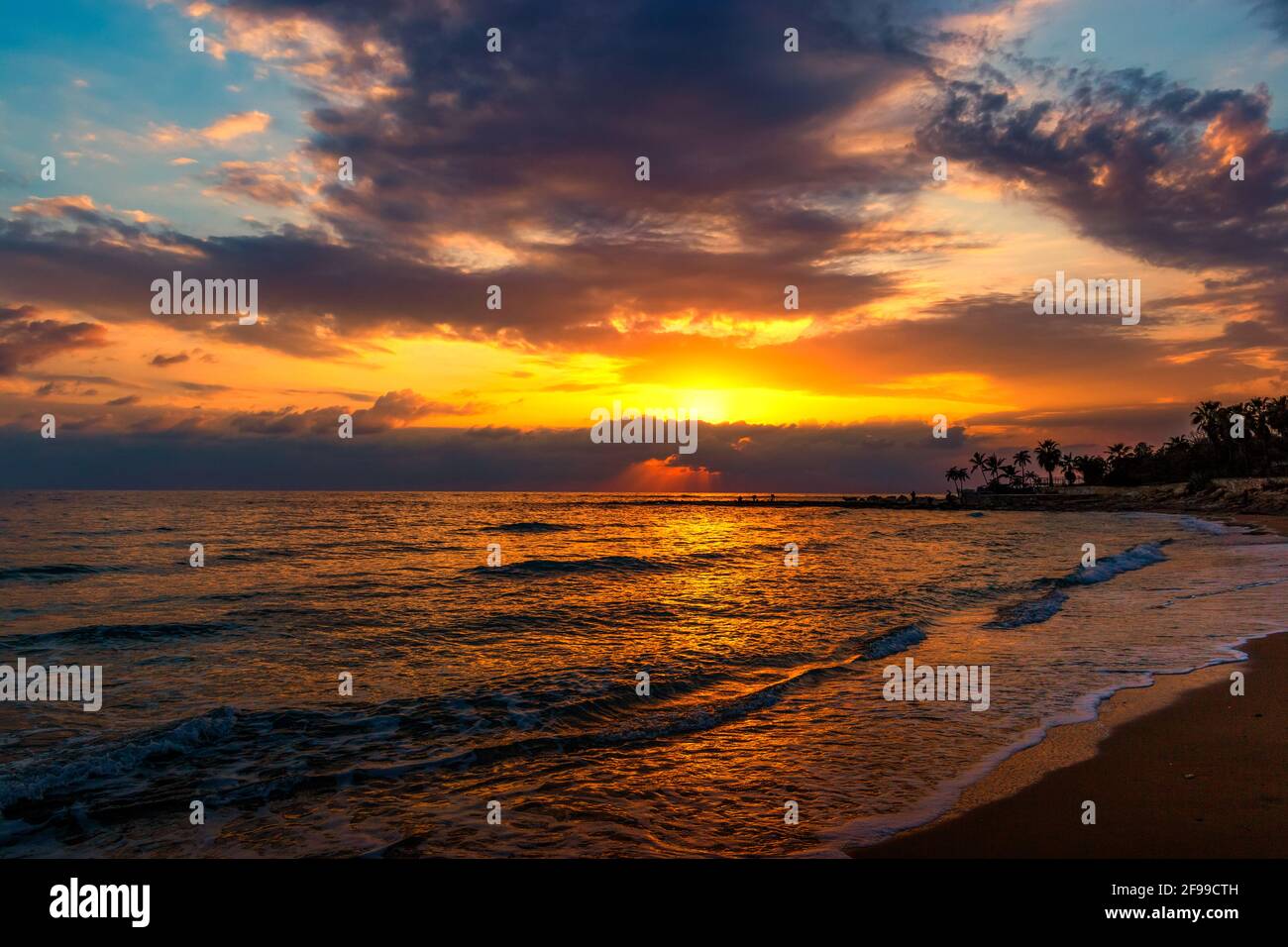 Sunset over ocean. Dramatic sky. Stock Photo
