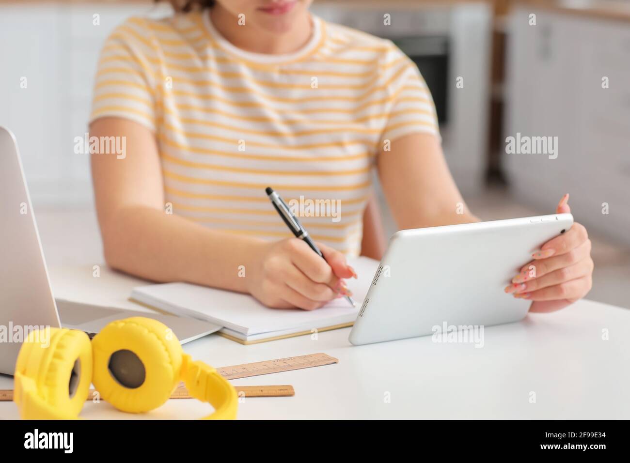 Female student studying online at home Stock Photo
