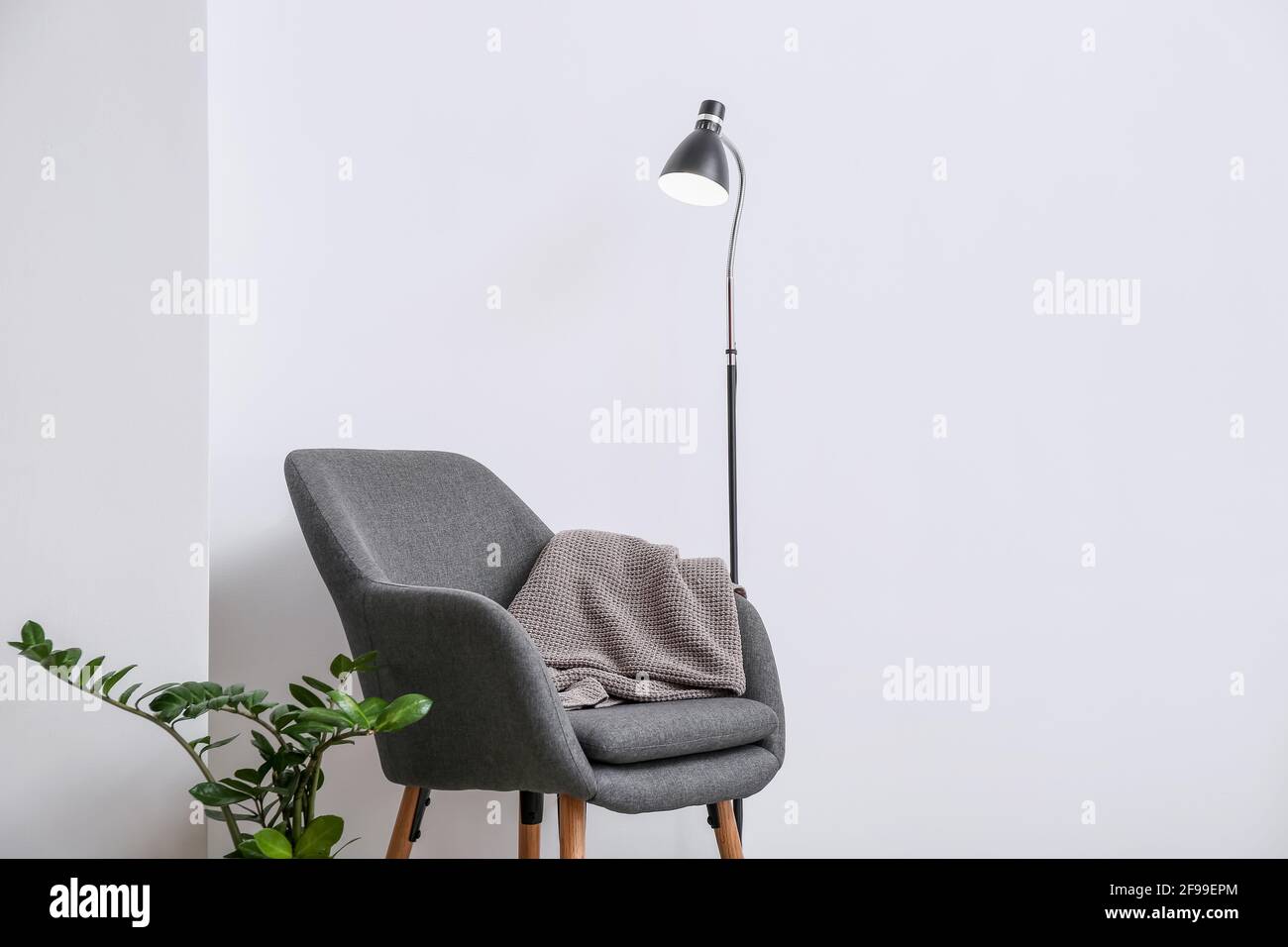 Interior of modern room with lamp and armchair Stock Photo - Alamy