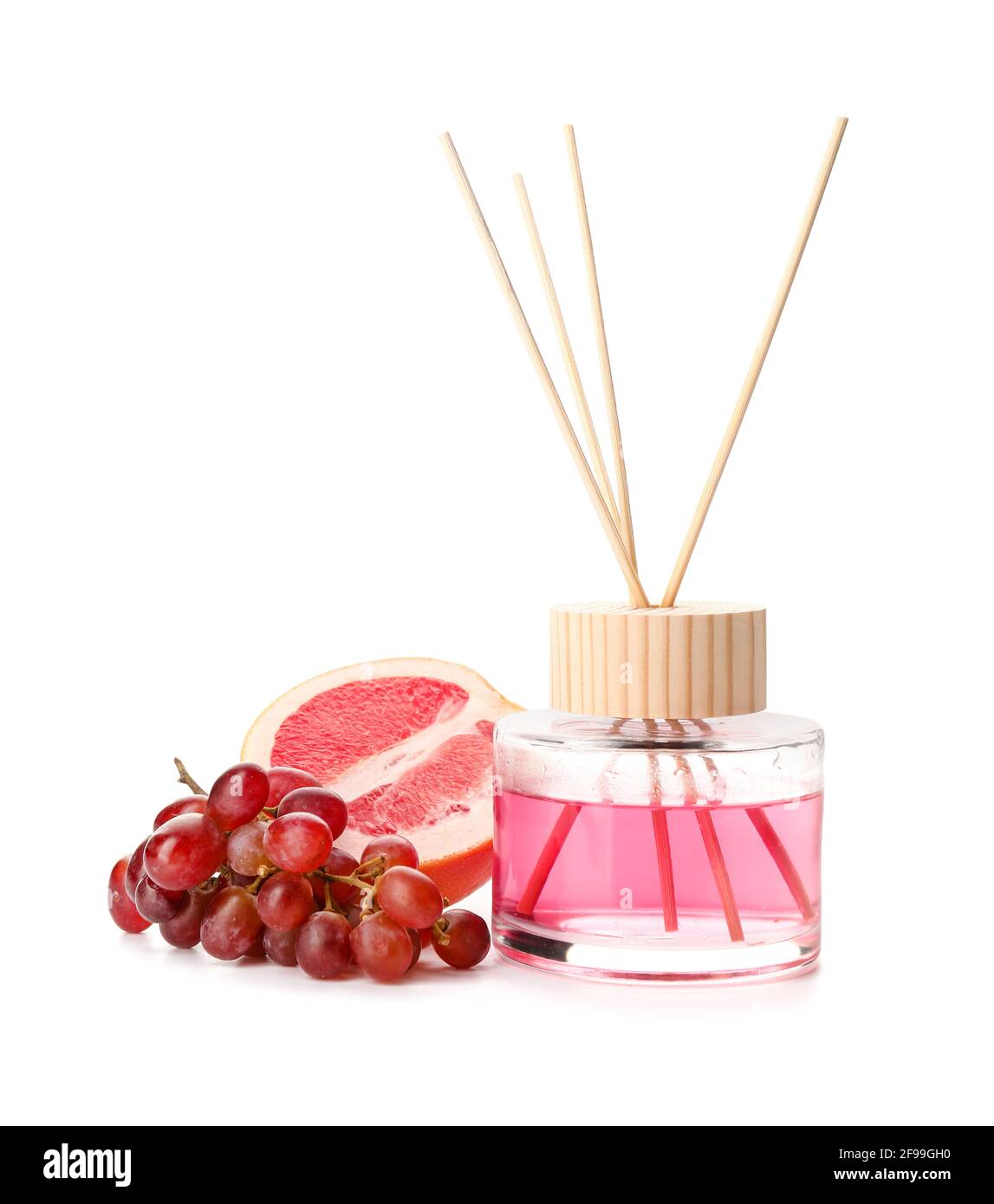 Reed diffuser with grape and grapefruit on white background Stock Photo