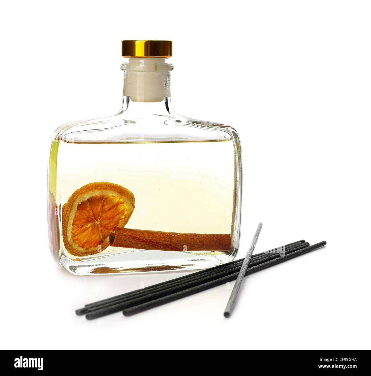 Reed diffuser with cinnamon and orange on white background Stock Photo