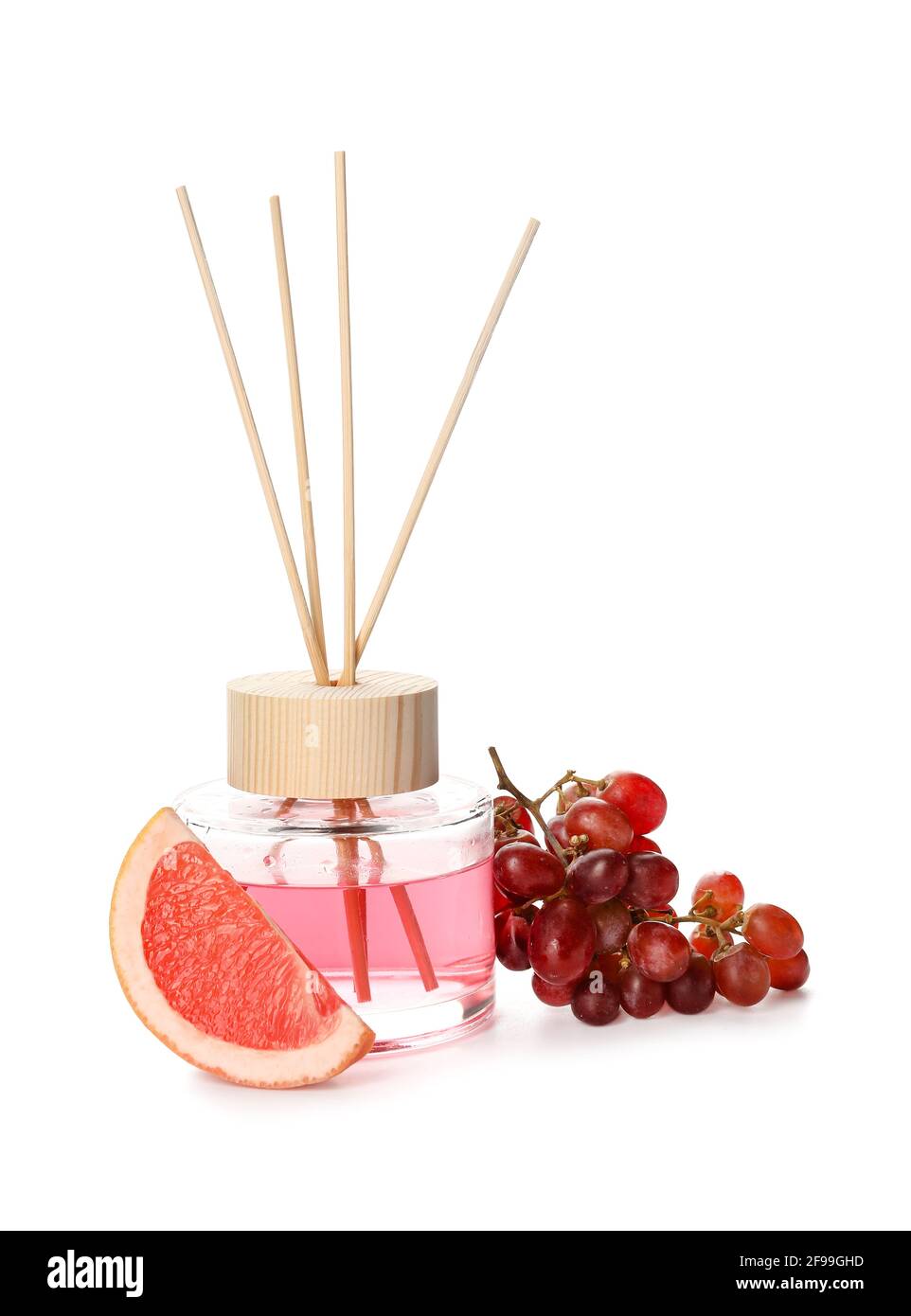 Reed diffuser with grape and grapefruit on white background Stock Photo