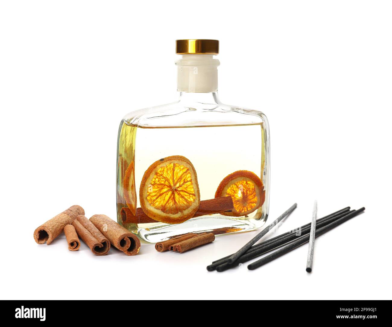 Reed diffuser with cinnamon and orange on white background Stock Photo