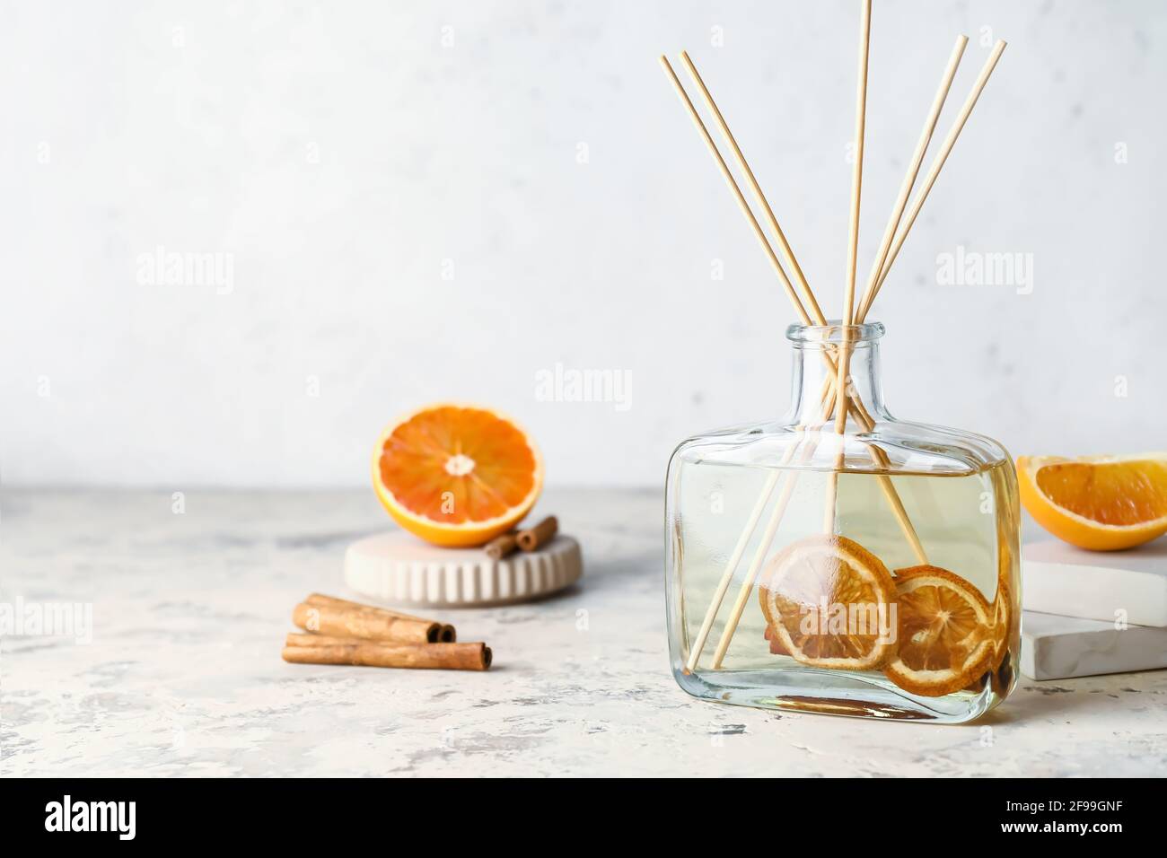 Citrus reed diffuser with cinnamon on table Stock Photo