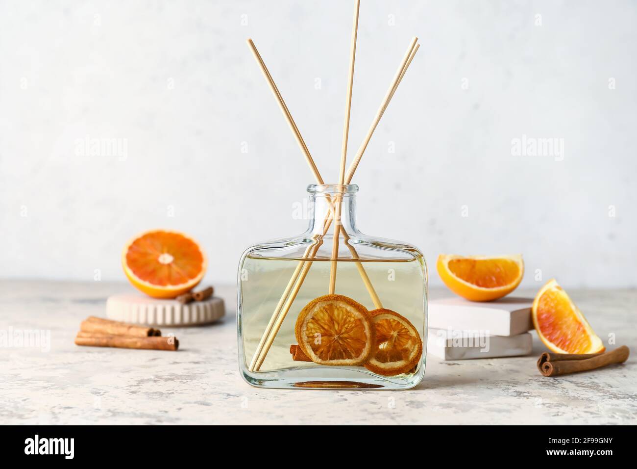 Citrus reed diffuser with cinnamon on table Stock Photo