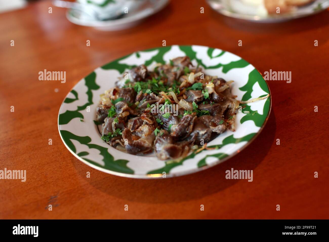 Stewed giblets on the plate in a restaurant Stock Photo Alamy