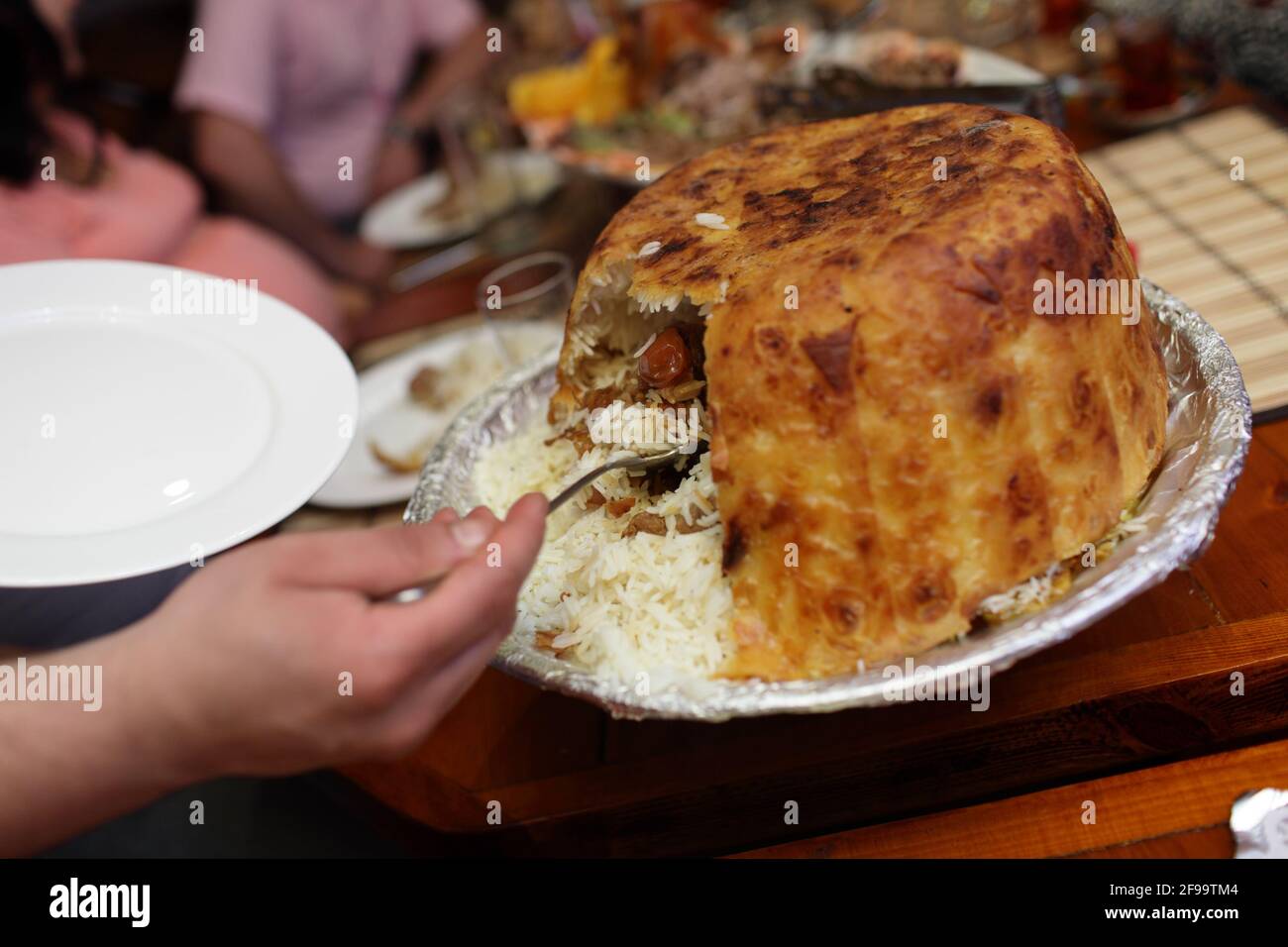 Waiter takes Khan pilaf in a restaurant Stock Photo Alamy