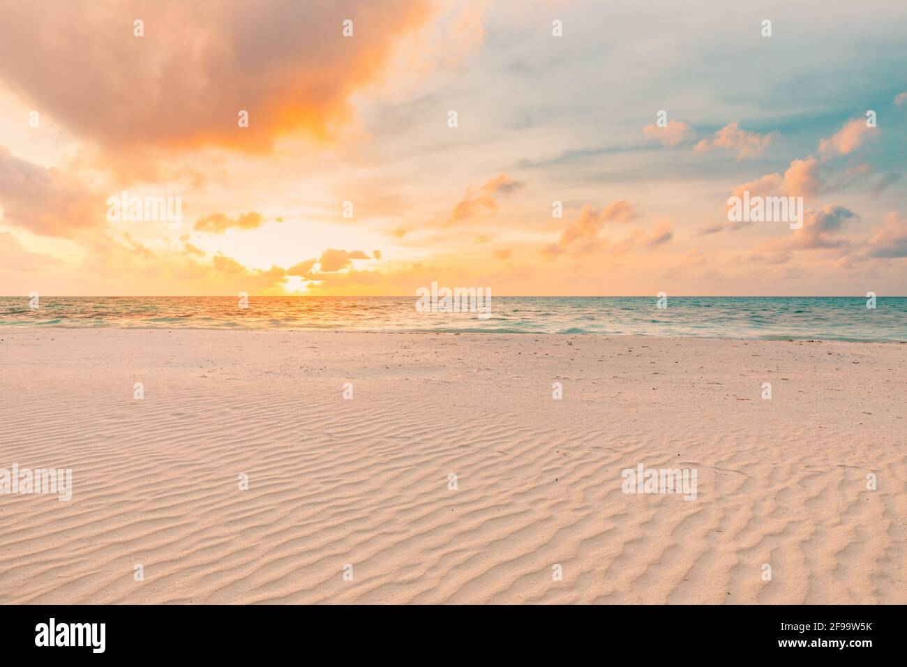 Closeup sea sand beach. Panoramic beach landscape. Inspire tropical beach seascape horizon. Orange and golden sunset sky calmness tranquil relaxing Stock Photo