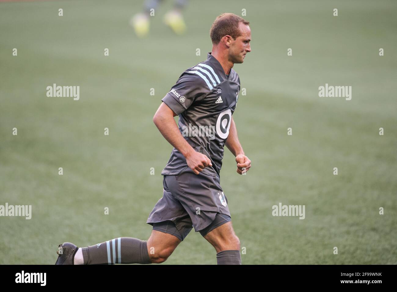 Minnesota United FC defender Chase Gasper (77) runs down the pitch during the first half of an MLS match against the Seattle Sounders FC at Lumen Fiel Stock Photo