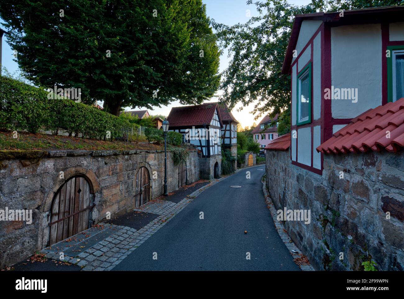 City wall, city fortifications, cellar house, facade, half-timbered, alley, architecture, Haßberge, Ebern, Franconia, Bavaria, Germany, Europe Stock Photo