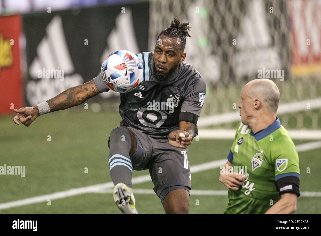 Minnesota United FC defender Romain Metanire (19) attacks the ball against Seattle Sounders FC defender Brad Smith (11) during the second half of an M Stock Photo